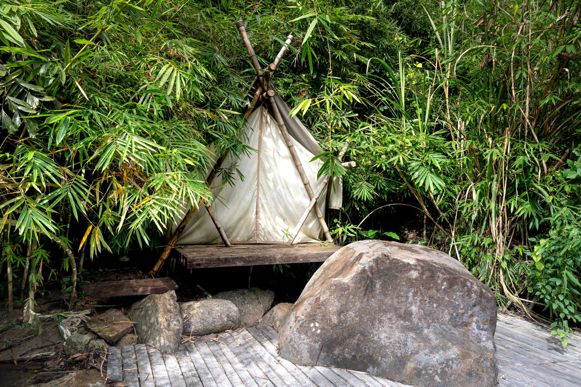Canvas safari tent with wooden deck under acacia trees near Nairobi