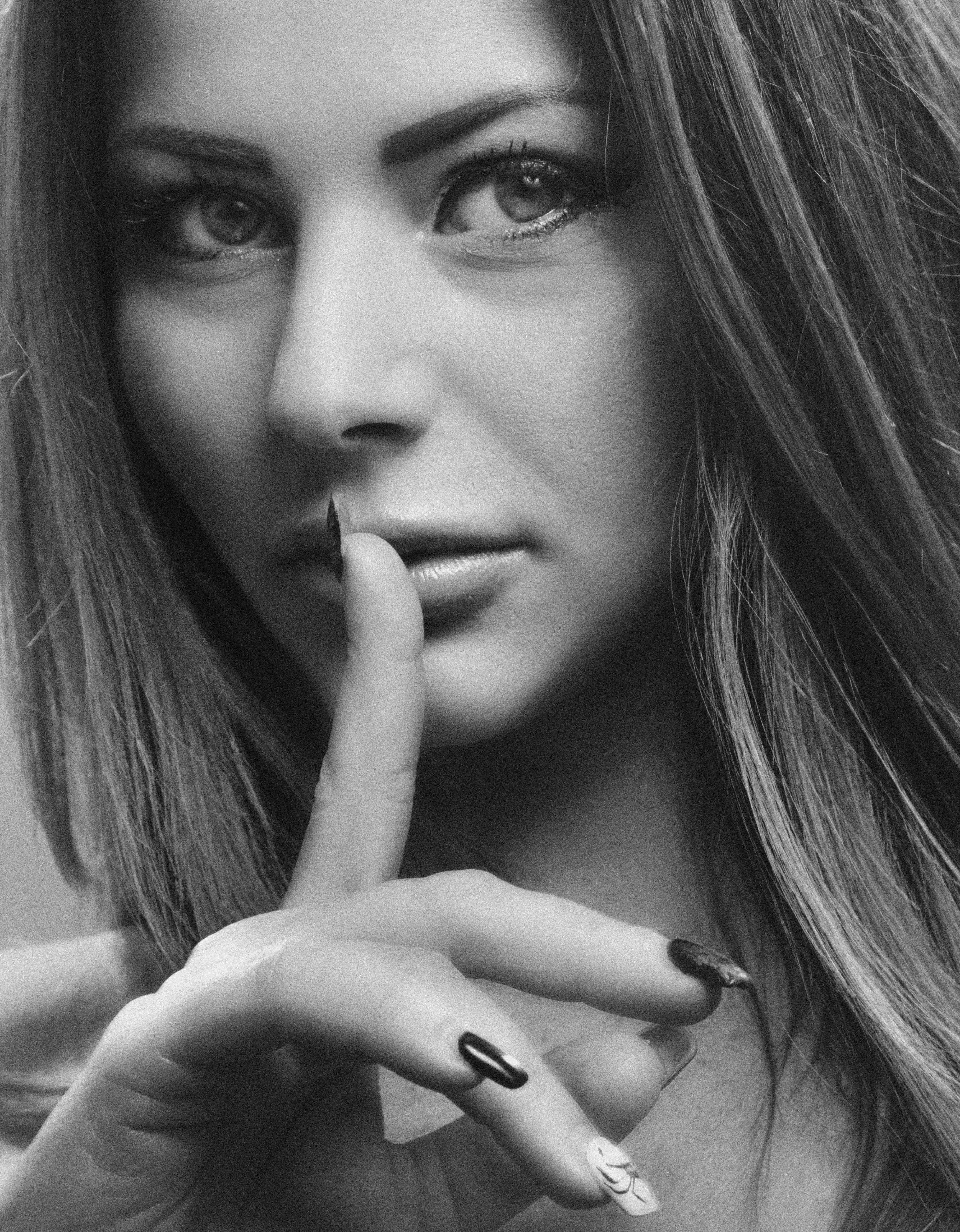 Woman with a Finger on her Lips · Free Stock Photo