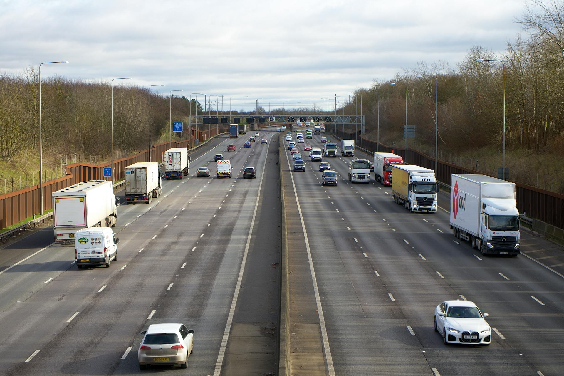 Aerial view of vehicles on a busy motorway in St Albans, UK during daylight.