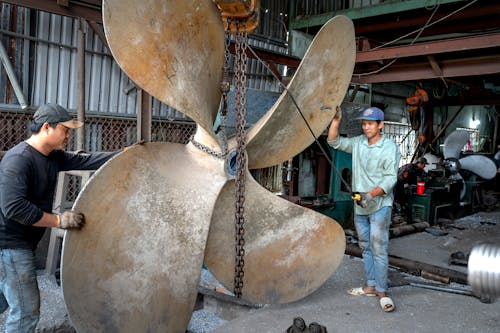 Men Working on a Ship Propeller 