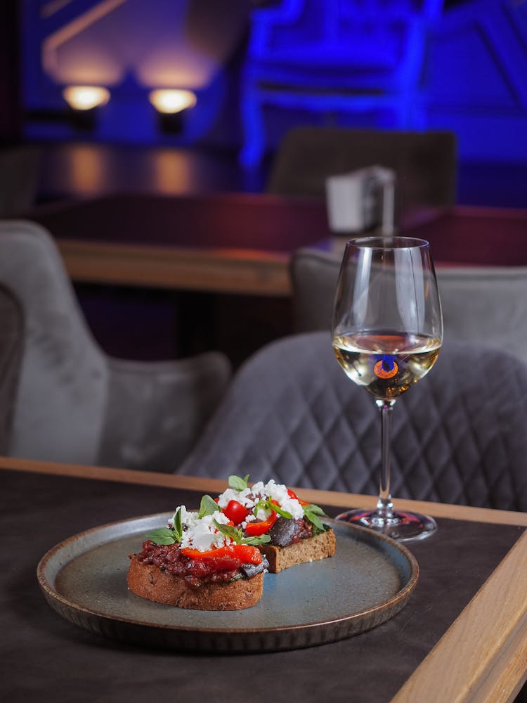 Food And A Glass Of Wine Served In A Restaurant 