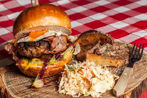 Meat Burger With Coleslaw on Side and Brown Handled Fork