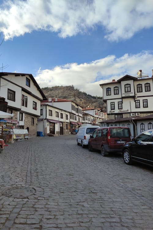 Cars Parked on an Uphill Cobbled Road