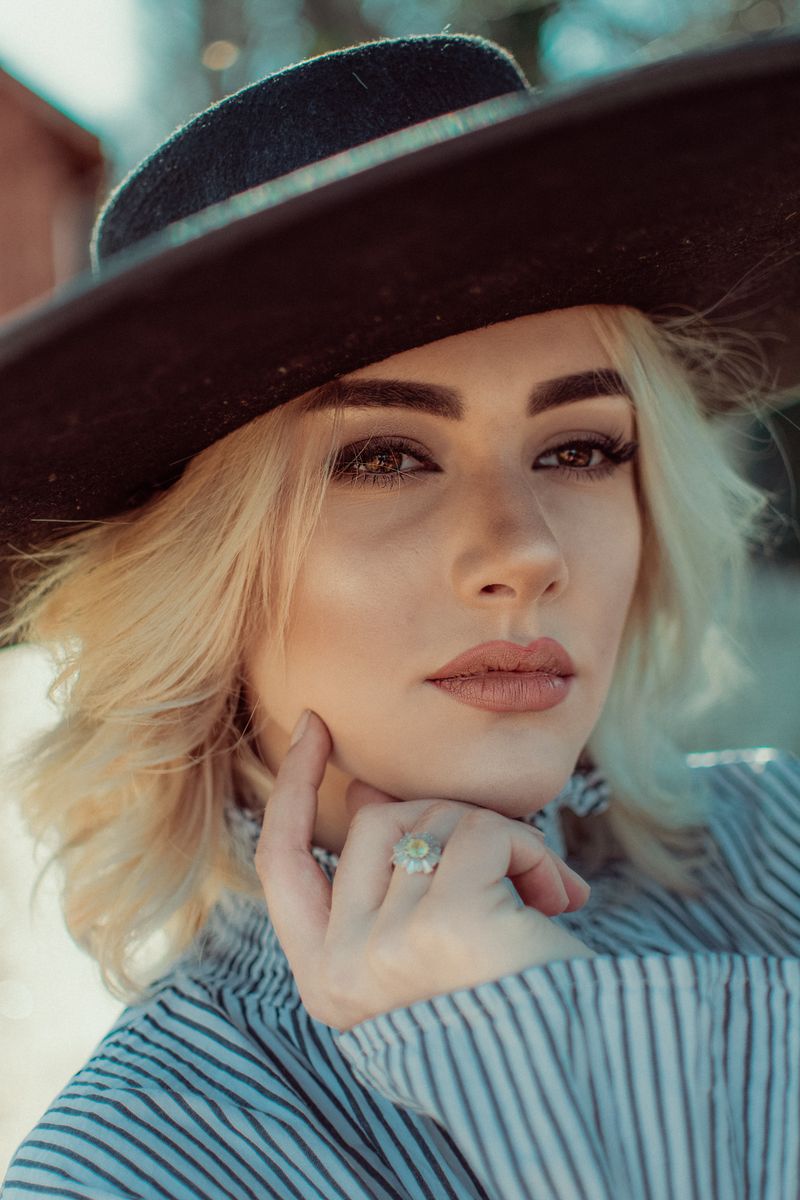 Beautiful Young Woman Wearing a Black Hat · Free Stock Photo