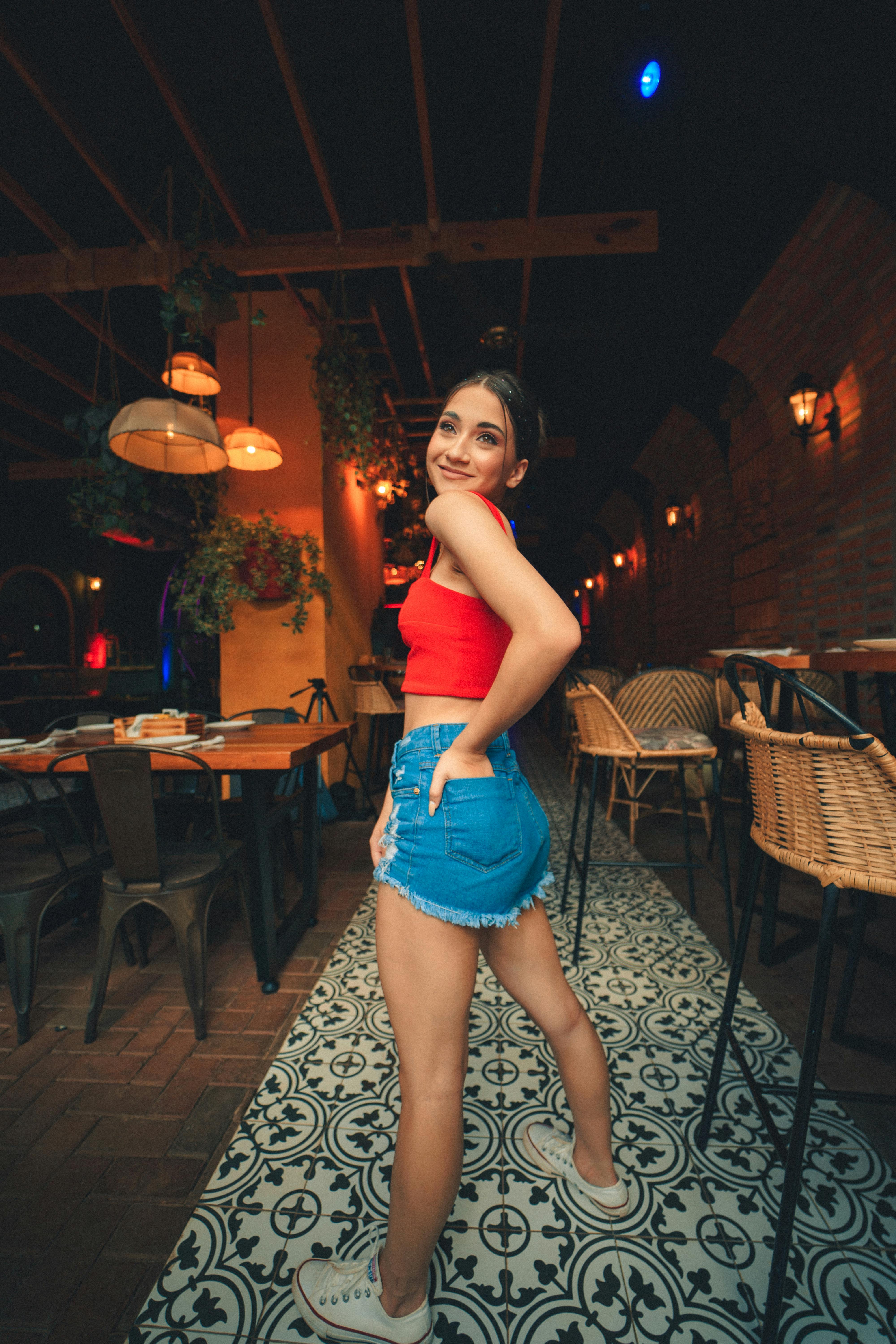 Woman in a Restaurant Standing with her Hand in Back Pocket · Free