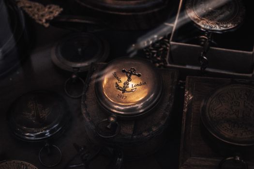 Close-up of a vintage 1917 Stanley London brass compass with nautical motifs and antique charm.