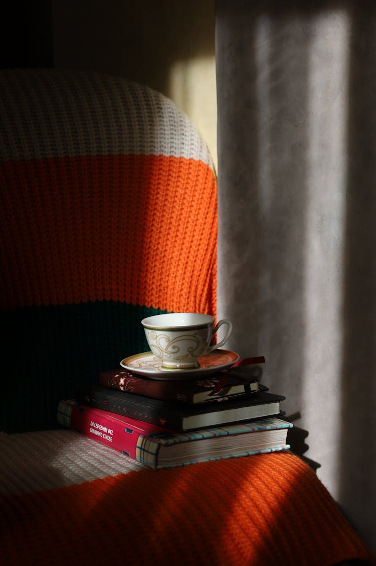 Shadows And Sunlight On Cup And Books