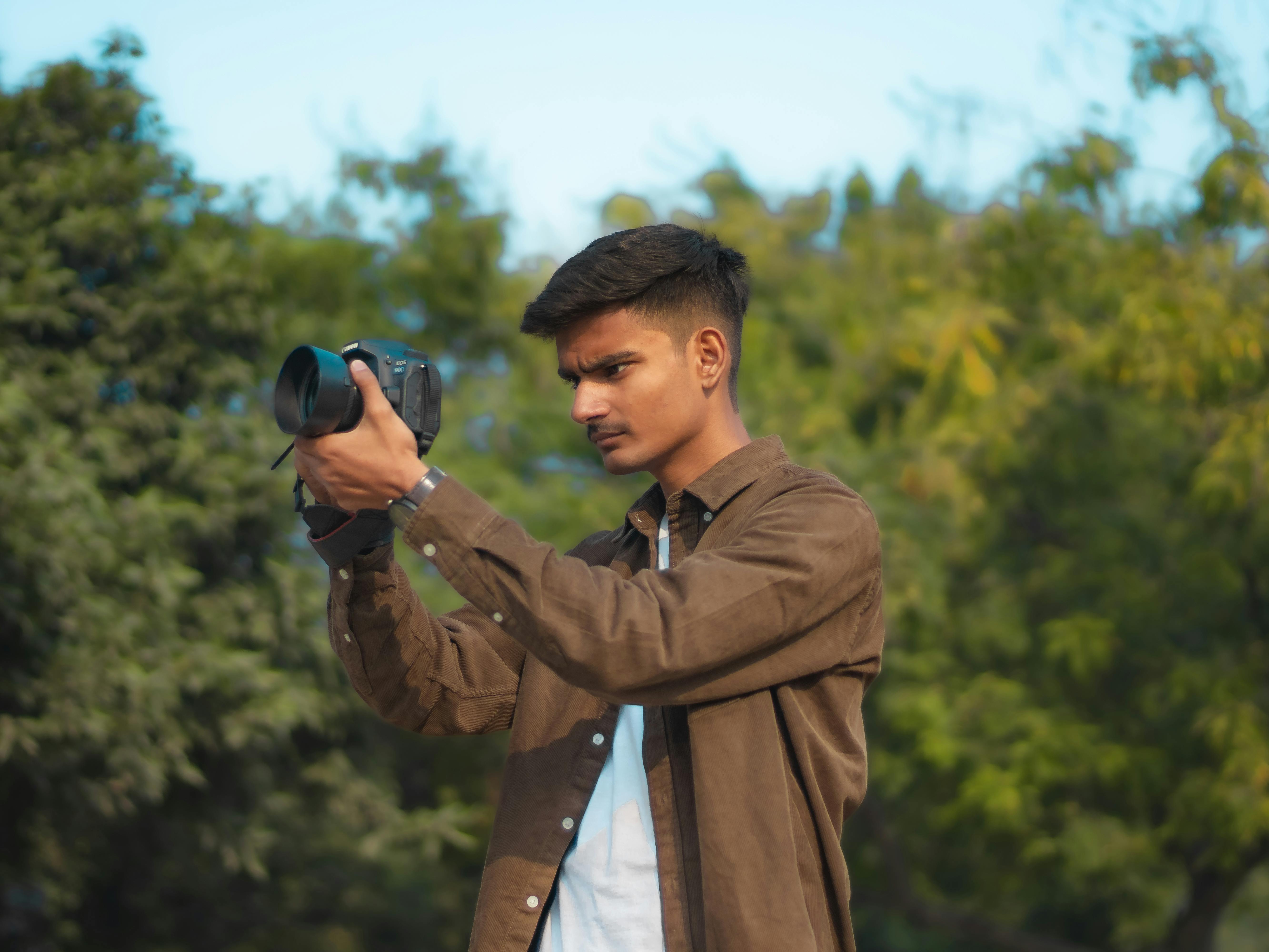 Free Photos - A Young Boy Standing In Front Of A Brown Curtain, Striking A  Pose For The Camera. He Is Wearing Casual Clothes, Including A Crop Top And  Shorts, And Is