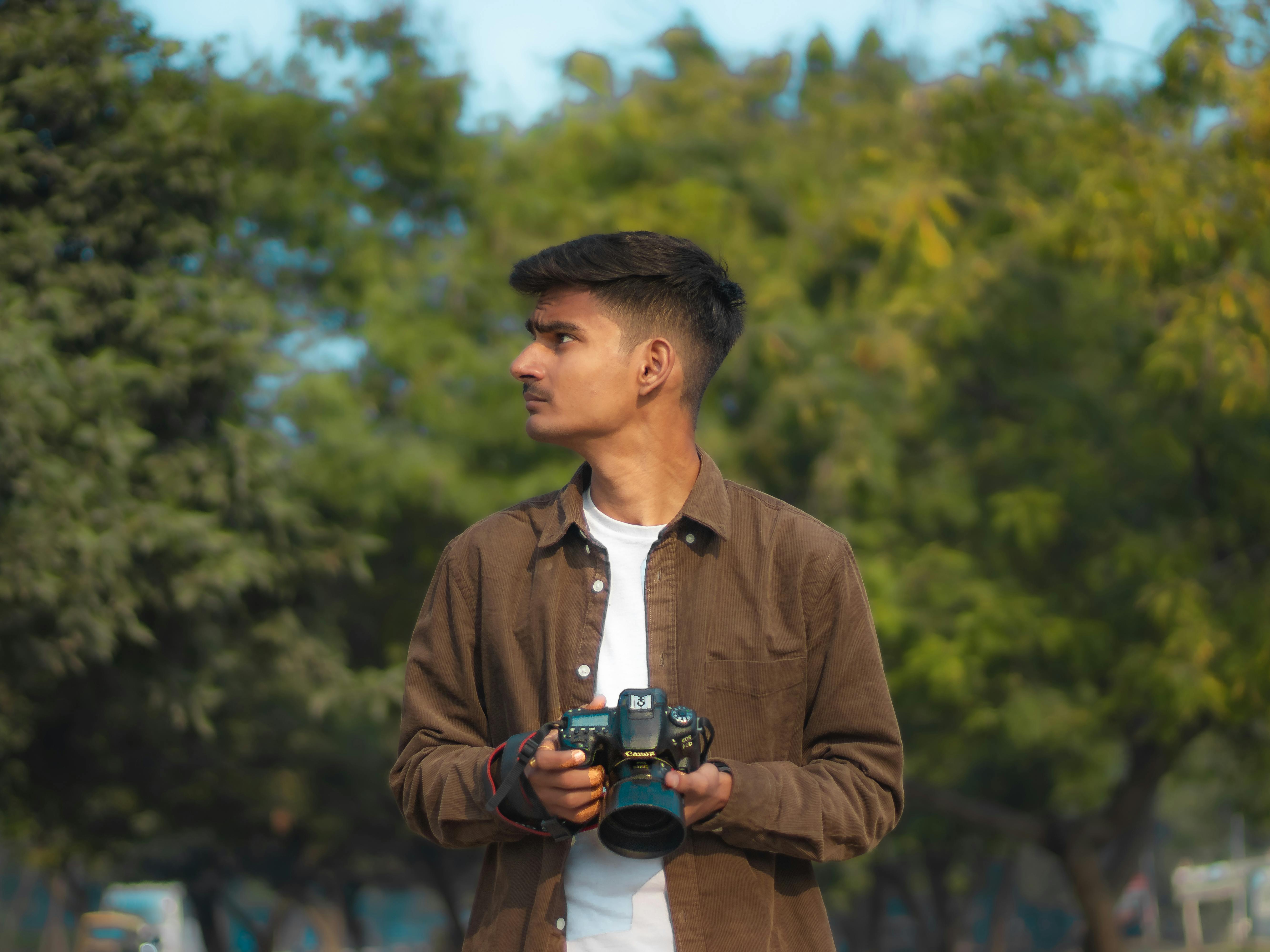 Stylish indian young man photographer wear casual posed outdoor with dslr  photo camera at hands Stock Photo - Alamy