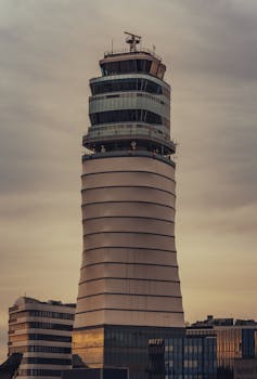 Stunning view of the Vienna Airport Control Tower captured at sunrise, highlighting its modern architecture.