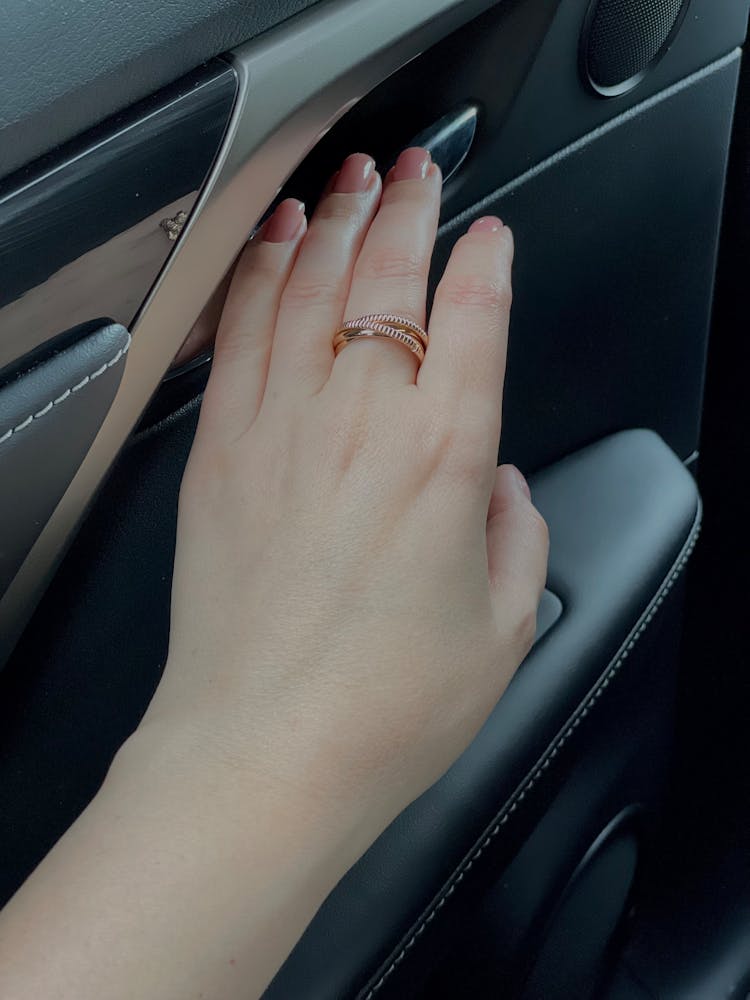 Woman Holding Hand On Car Door Latch