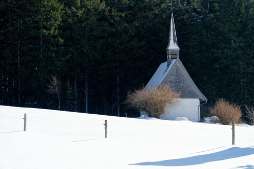 Free Chapel nestled in snowy landscape, Black Forest, Germany. Stock Photo