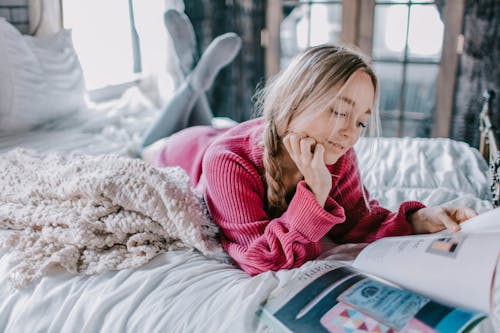 Free Woman Reading Book On Bed Stock Photo