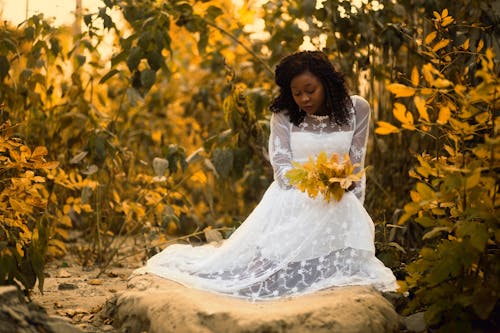 Woman Wearing White Long-sleeved Gown Holding Bouquet