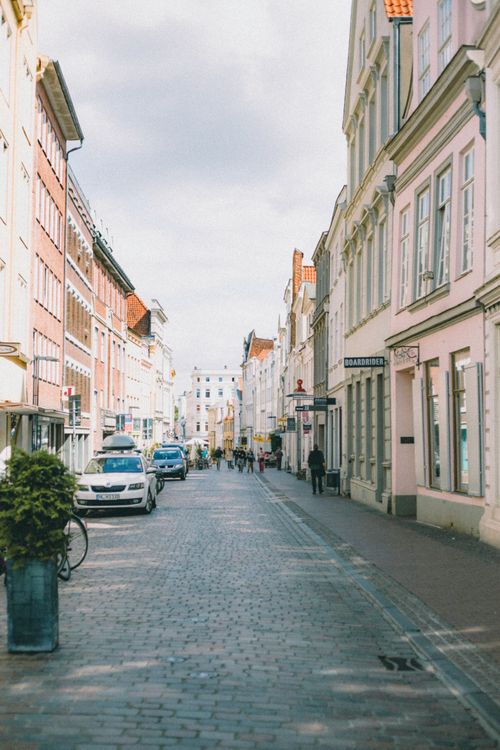 Free Quaint street view with historic buildings and cars in a European old town. Stock Photo