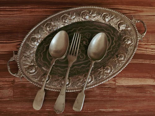 Free Antique Spoons and Fork on Plate Stock Photo