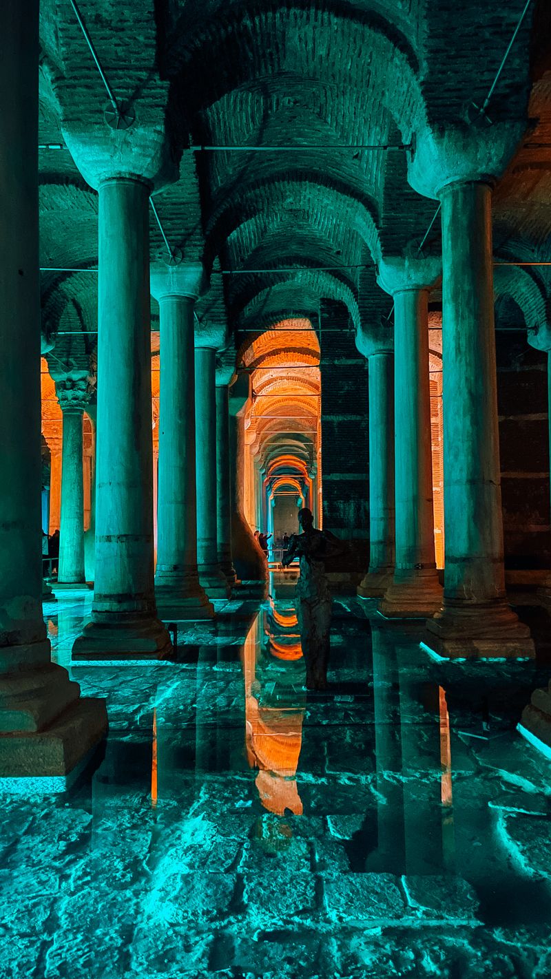Illuminated columns and water reflections inside the Basilica Cistern