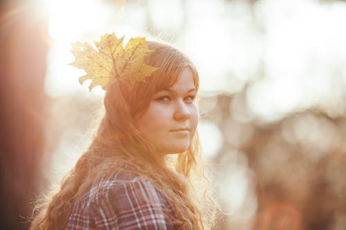 Woman Wearing White Red and Gray Plaid Shirt With Leaf Headdress