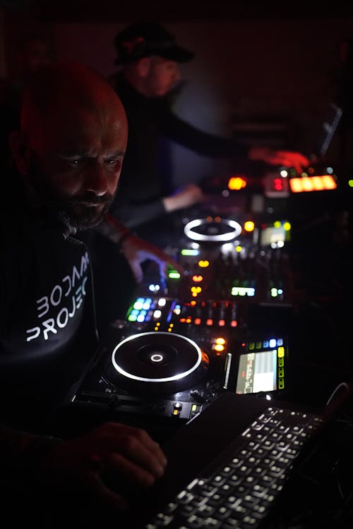 DJs Using Sound Mixers at a Party in a Nightclub 