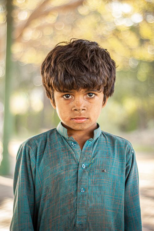 Free A young boy in traditional clothing standing outdoors during fall in Karachi, Pakistan. Stock Photo