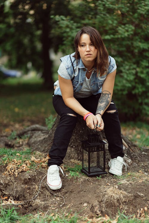 Woman Wearing Blue Denim Vest Sitting Tree Log