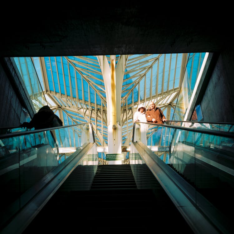 People On Escalators At Airport