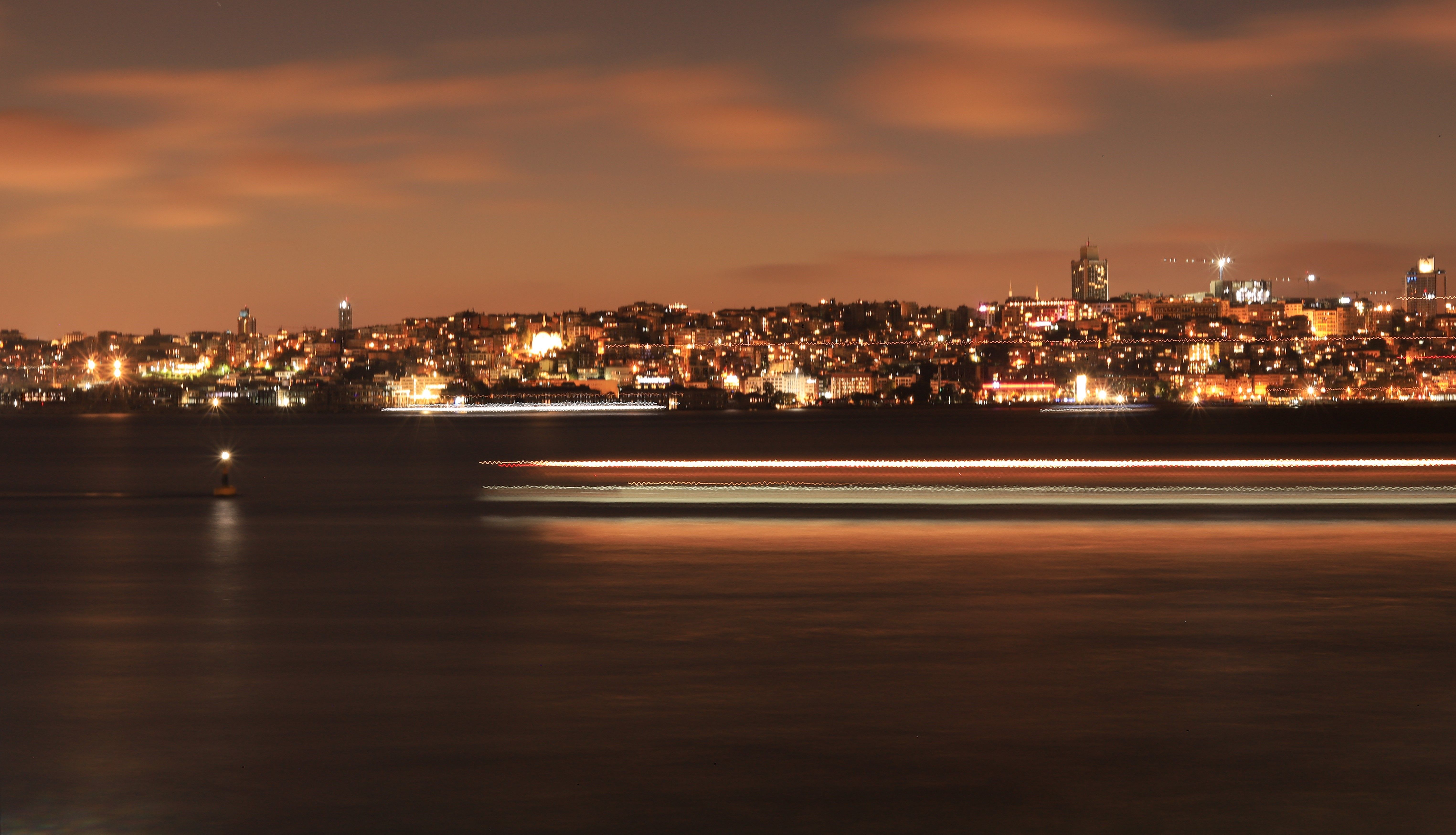 A vibrant night view of Istanbul cityscape with illuminated skyline and waterfront.