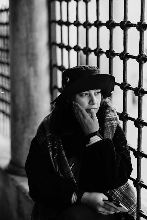 Black and White Photo of a Woman Touching her Face 