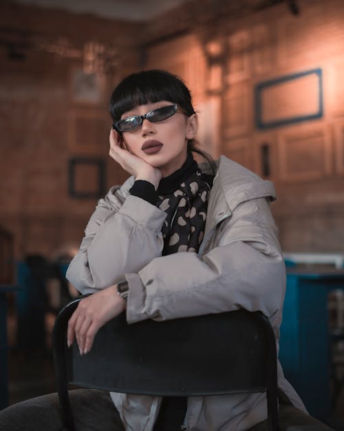 Photo of a Cool Young Woman Sitting in a Room