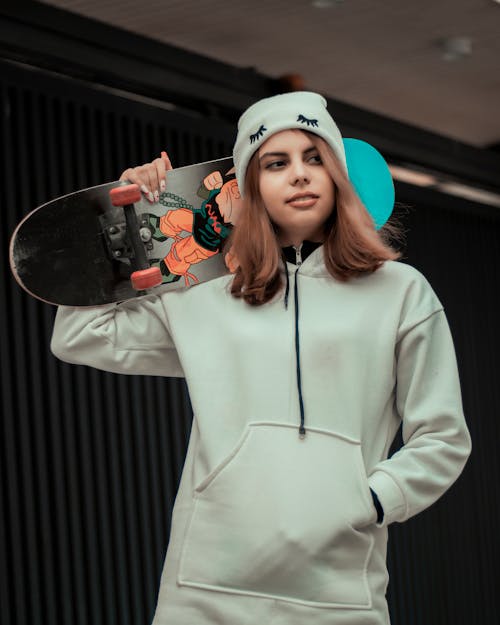 Photo of a Cool Young Woman with a Skateboard