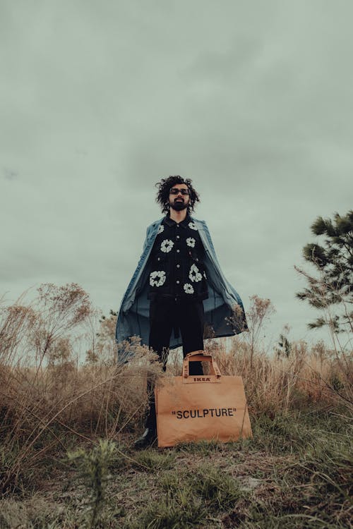 Man with Bag on Grassland