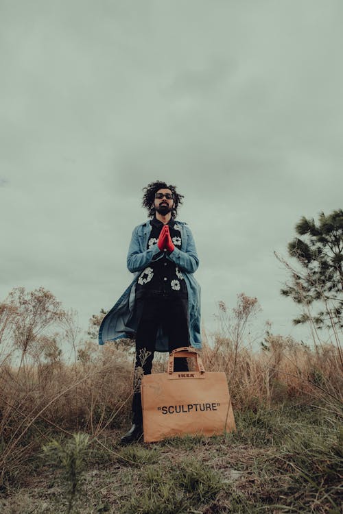 Man with Bag Posing on Field