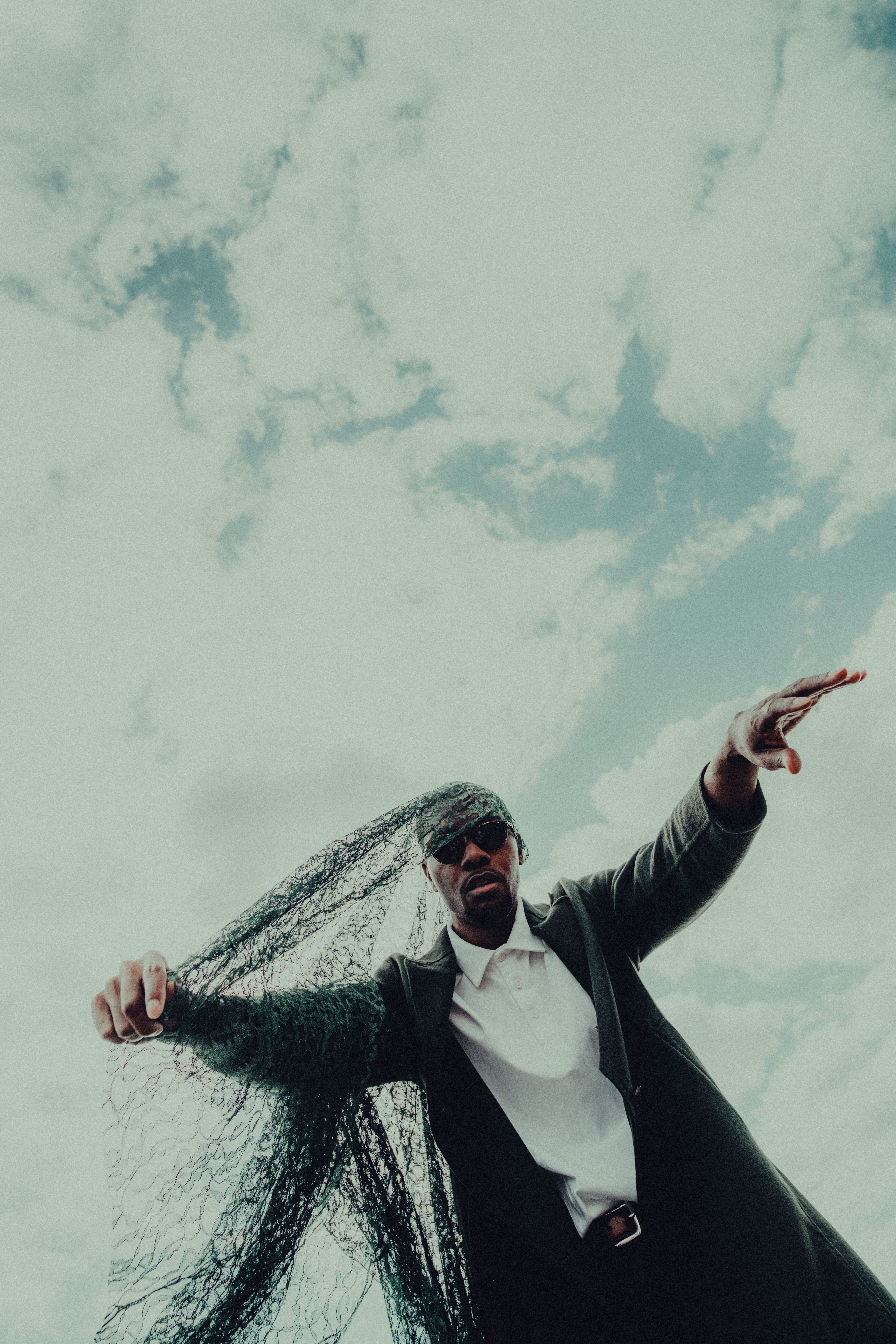 Man Standing under Cloudy Sky · Free Stock Photo
