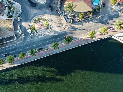 Aerial Photography of Paved Road Near Body of Water