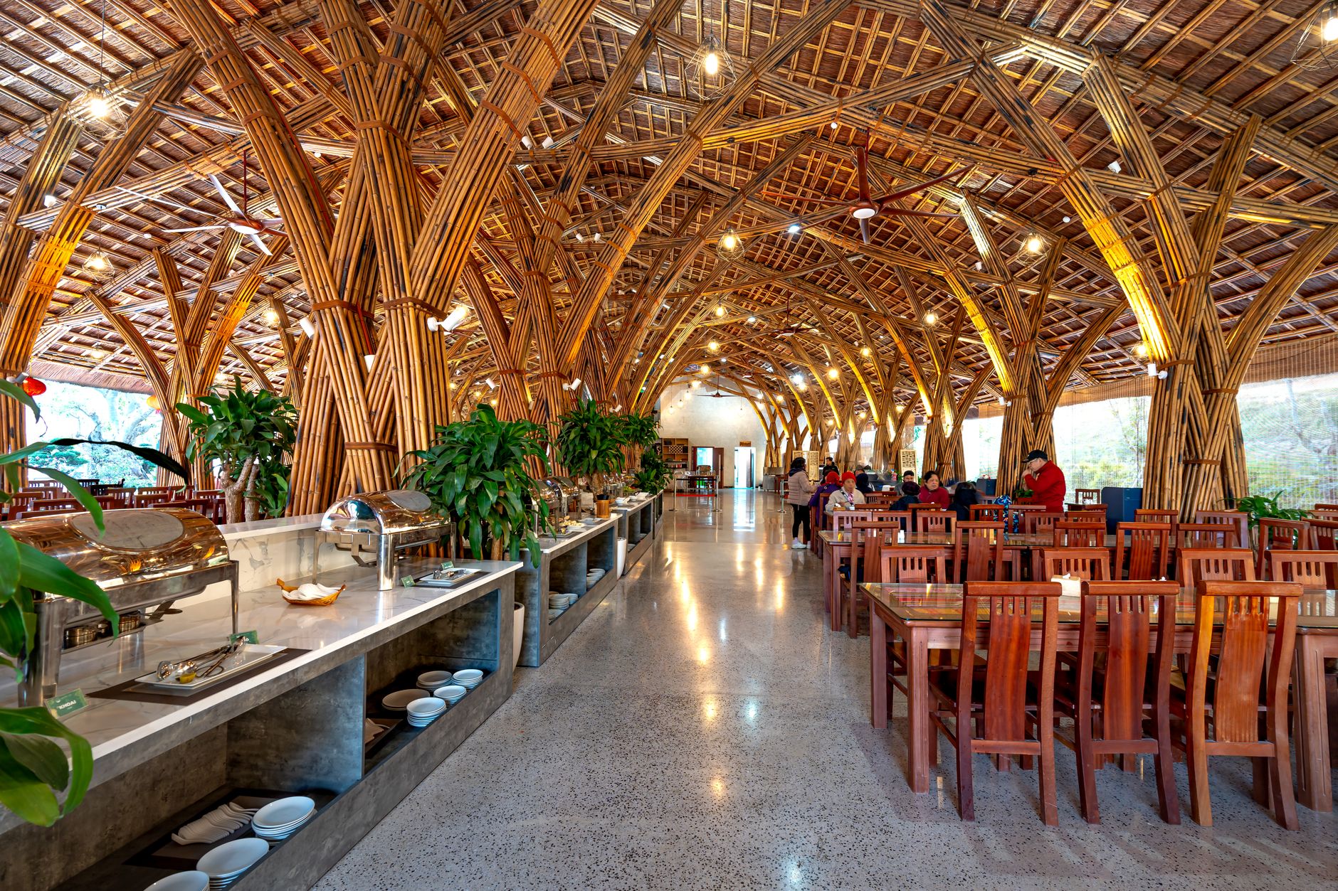 Stunning bamboo restaurant interior featuring elegant arches and wooden furniture with a modern buffet layout