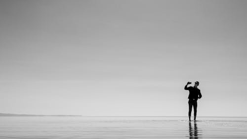 Lone Man Taking Photos with Smartphone on Beach