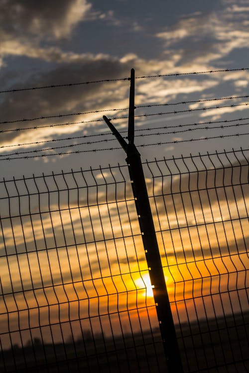 Gray Metal Fence during Sunset