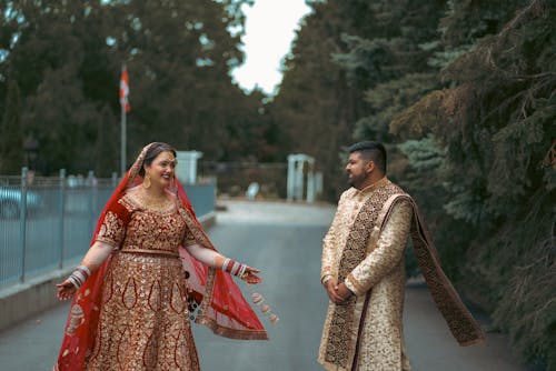 Happy Woman in Red Traditional Dress and Elegant Man on Street