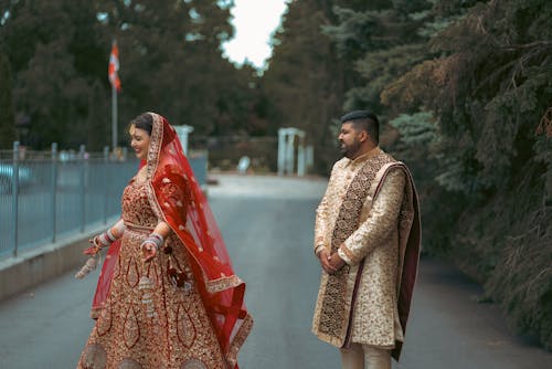 Woman in Red Dress and Elegant Man on Road