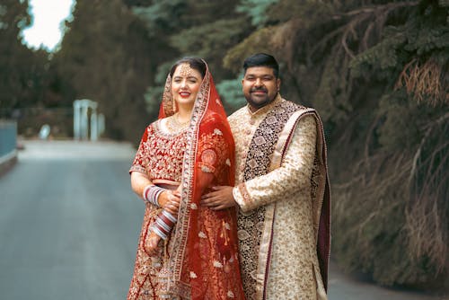 Woman and Man Posing in Traditional Clothing