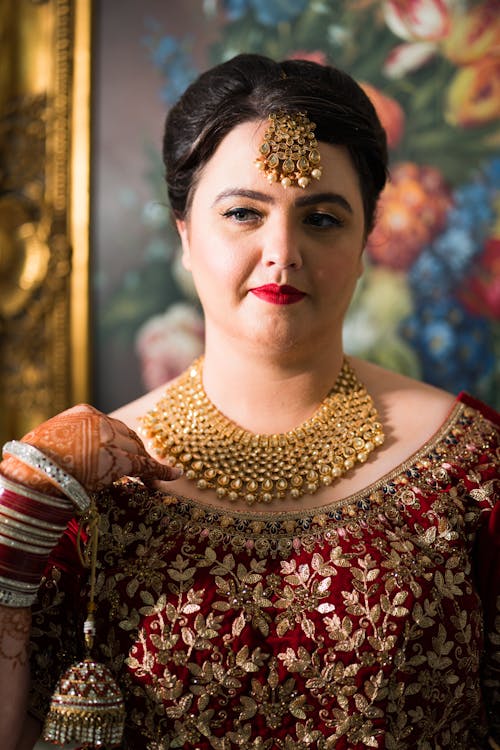 Elegant Woman in Red Dress with Golden Necklace