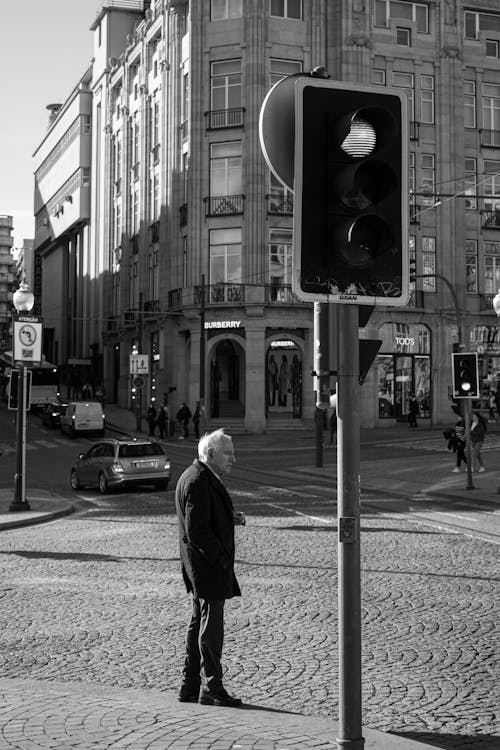 Elderly Man in Front of Traffic Light in Black and White 