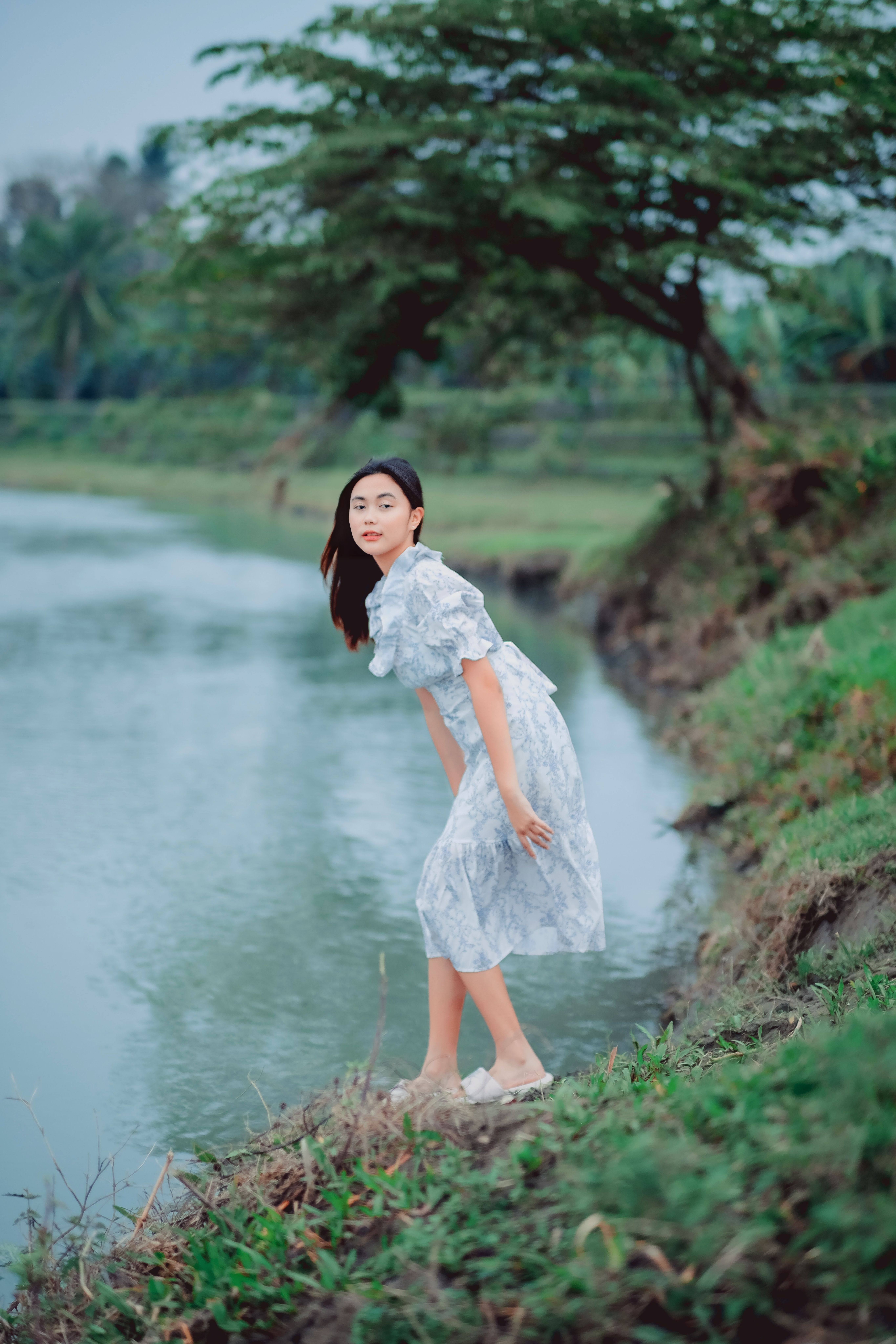 Woman in a Dress Standing by the River · Free Stock Photo