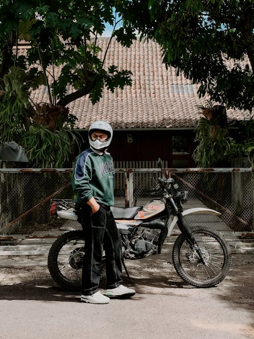 Man Standing next to the Motorcycle 