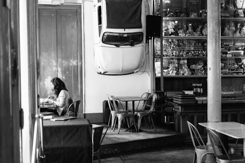 Grayscale Photo of Woman Sitting 