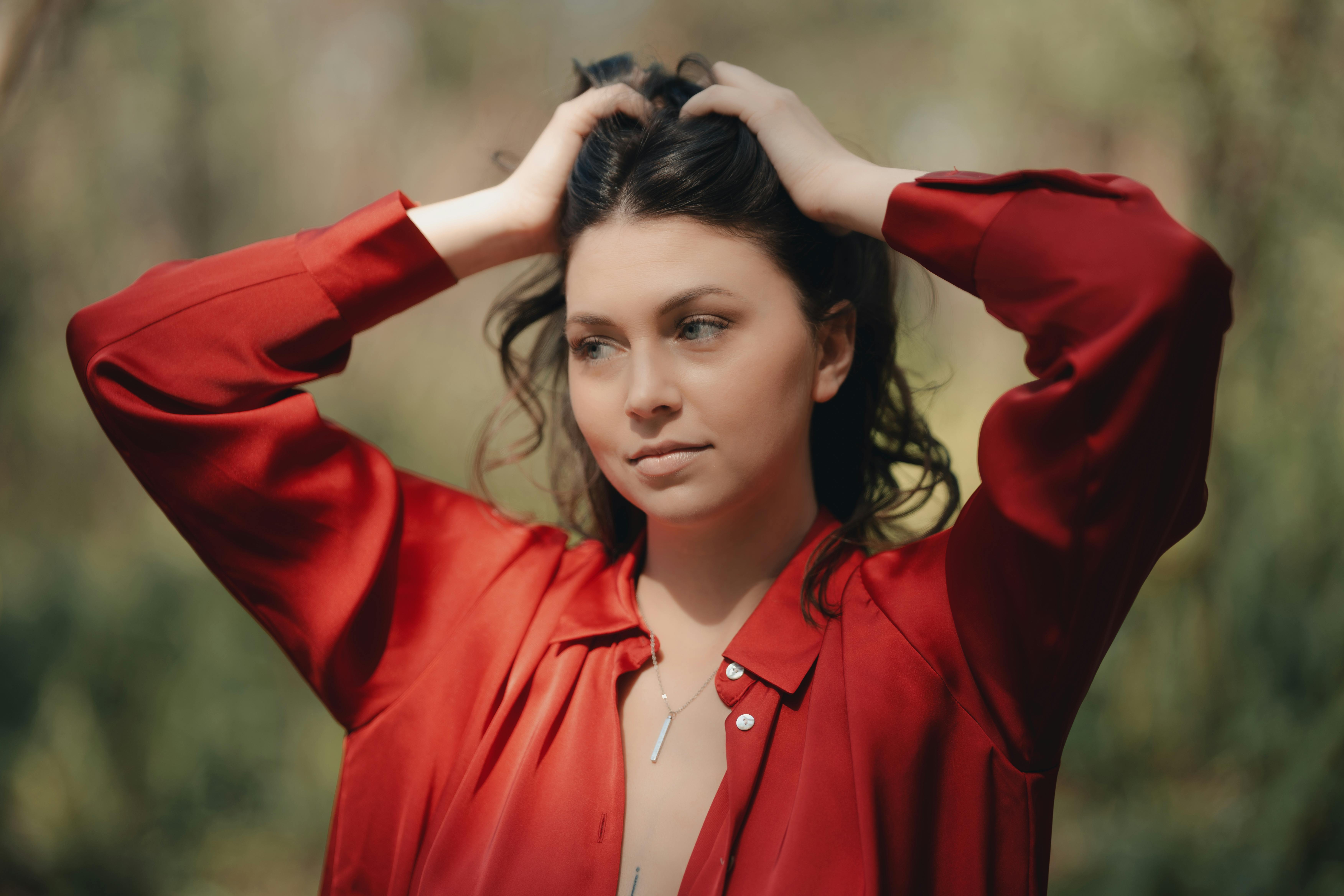 full length portrait of a pretty brunette girl wearing a red shirt