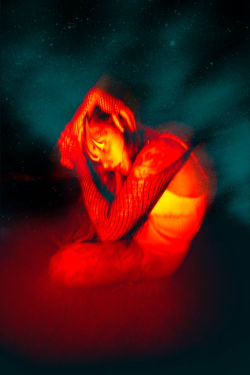 Free Abstract red portrait with unique lighting and blurred motion creating a surreal effect. Stock Photo