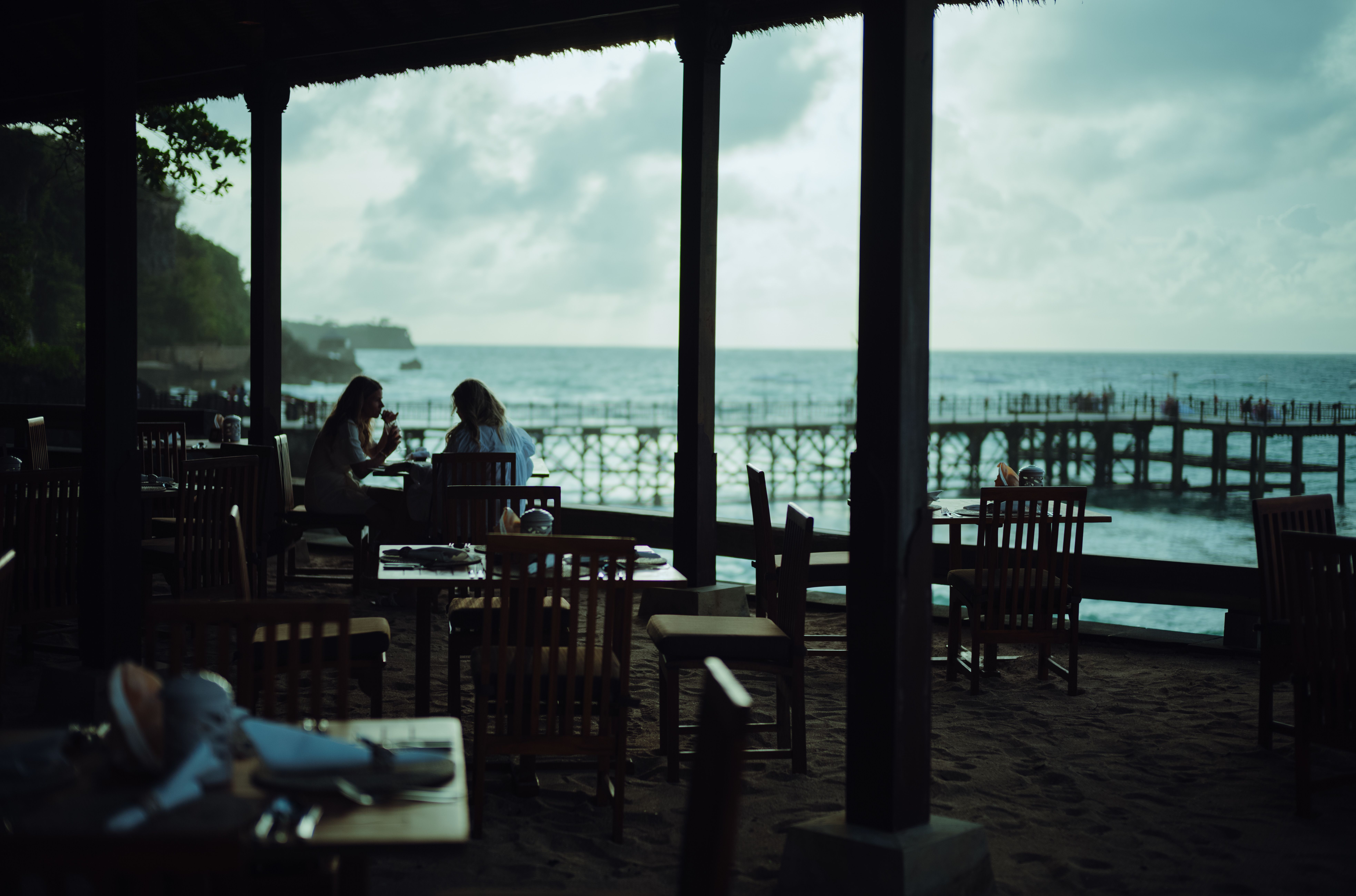 cliffside wooden café overlooking Bingin Beach with a laptop on a wooden table