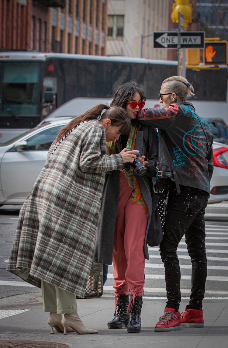 Candid Photo Of A Group Of Young People Standing On The Sidewalk And Looking At The Camera Viewfinder 