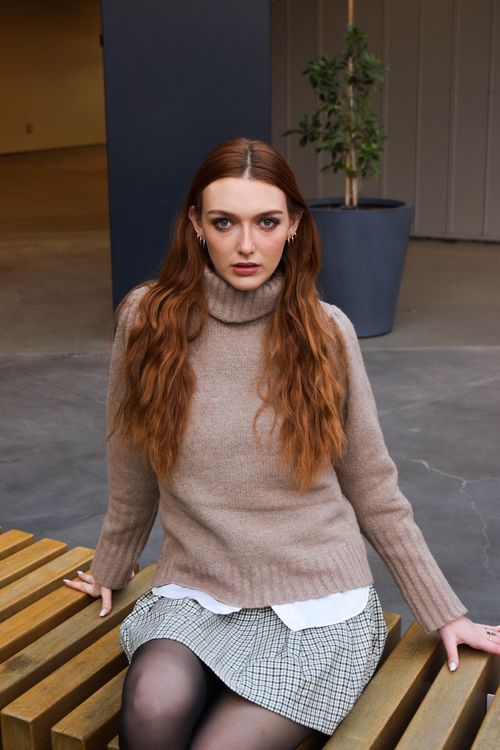 Woman in neutral turtleneck layers
